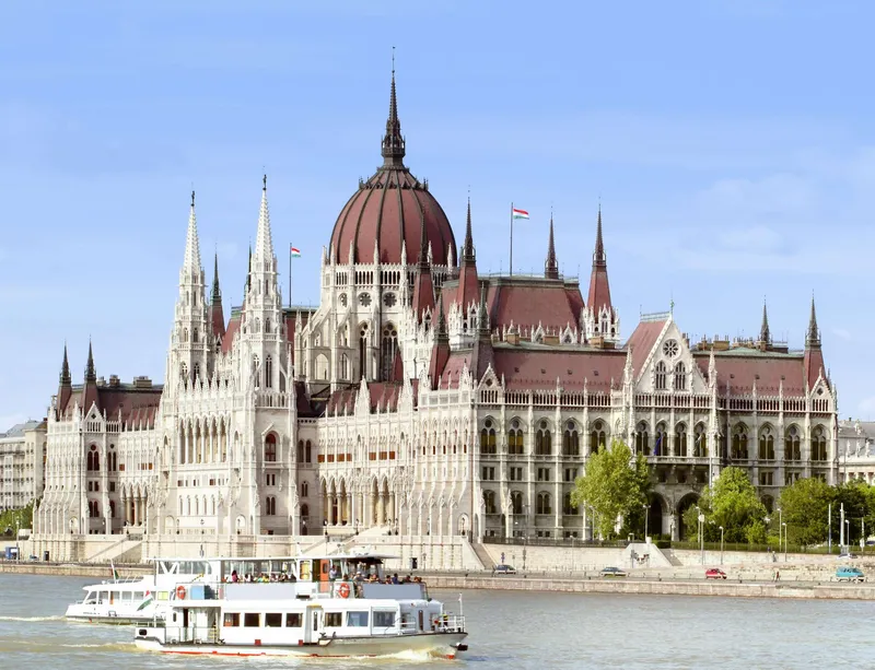 The magnificent interior of the Hungarian Parliament Building showing gilded columns and ornate carved stonework on a budapest hungarian parliament building guided tour